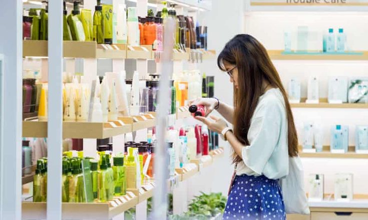 Person Comparing Skincare Products While Shopping